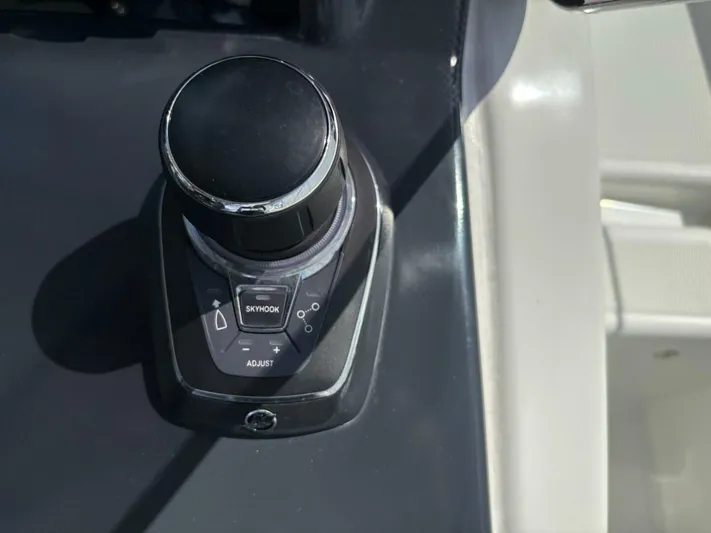  Yacht Photos Pics Joystick control on 2024 Jeanneau DB43 boat dashboard, featuring Skyhook and adjust buttons.