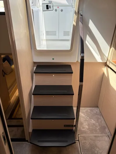  Yacht Photos Pics Staircase inside 2024 Jeanneau DB43 yacht, featuring sleek design and modern materials.