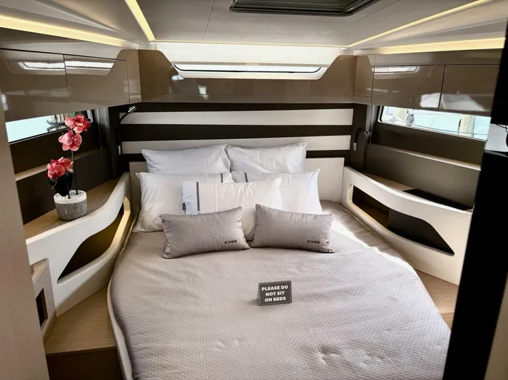  Yacht Photos Pics Luxurious cabin interior of 2024 Jeanneau DB43 yacht with elegant bedding and decor.
