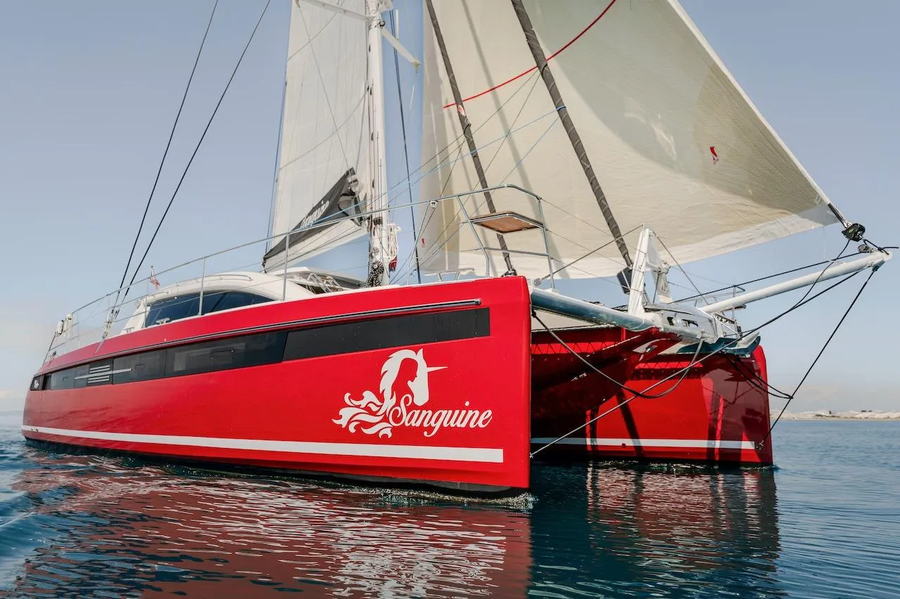 Red Privilege Signature 510 catamaran on calm water, year 2025.