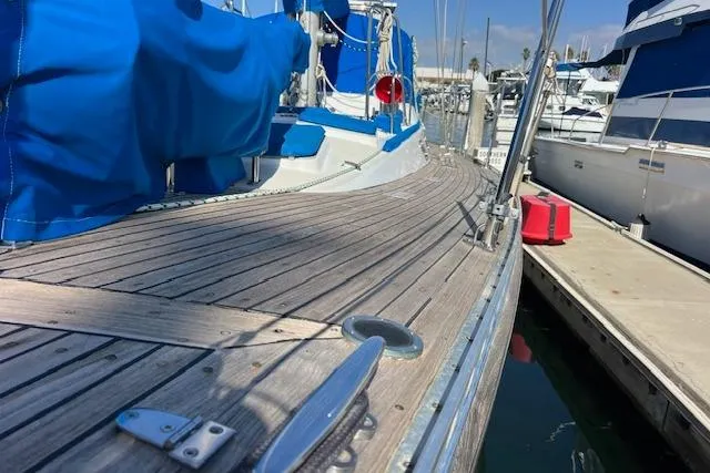 Southern Cross Yacht Photos Pics 1987 Tayana Vancouver 42 sailboat with wooden deck, docked at marina.
