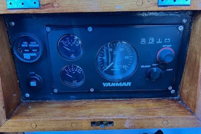 Southern Cross Yacht Photos Pics Yanmar engine control panel on 1987 Tayana Vancouver 42 sailboat, featuring gauges and switches.