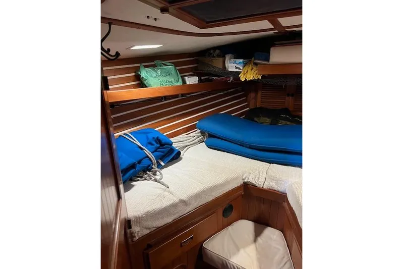 Southern Cross Yacht Photos Pics Cozy cabin interior of 1987 Tayana Vancouver 42 sailboat with wooden paneling and storage.