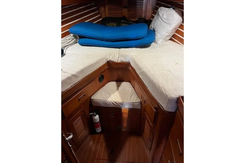 Southern Cross Yacht Photos Pics Cozy cabin interior of 1987 Tayana Vancouver 42 sailboat with wooden finish and bedding.