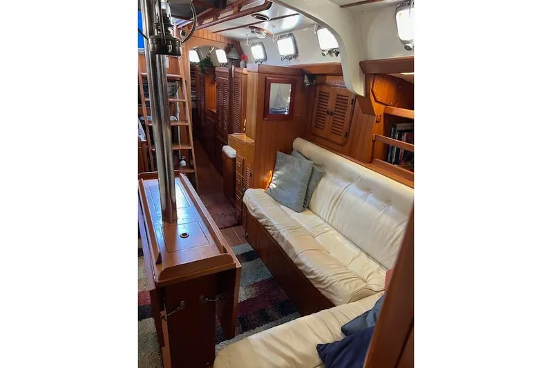 Southern Cross Yacht Photos Pics 1987 Tayana Vancouver 42 yacht interior with wooden finish and white leather seating.