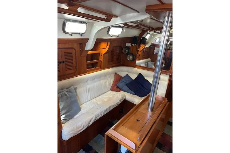 Southern Cross Yacht Photos Pics Interior of 1987 Tayana Vancouver 42 yacht with cozy seating and wooden cabinetry.
