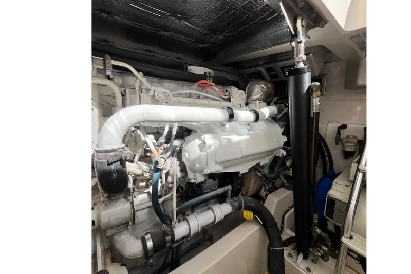  Yacht Photos Pics Engine compartment of a 2004 Cabo 35 Express boat, showcasing detailed mechanical components.