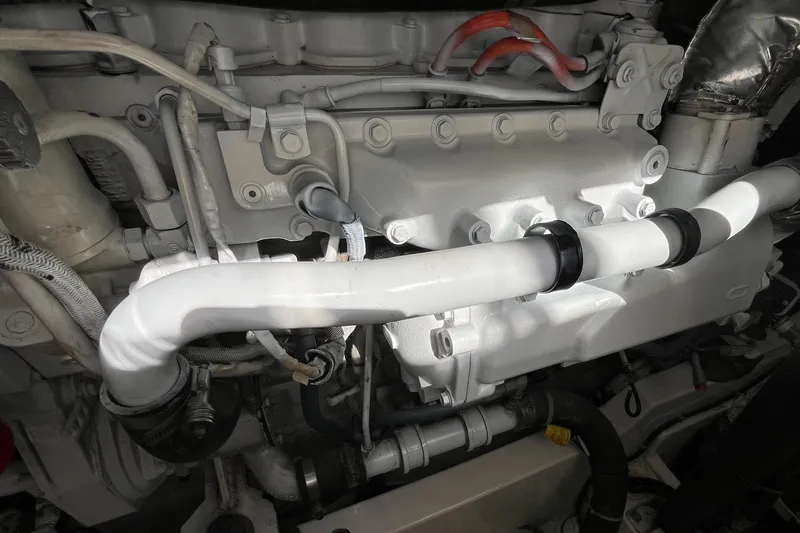  Yacht Photos Pics Engine components of a 2004 Cabo 35 Express boat, featuring white pipes and connectors.