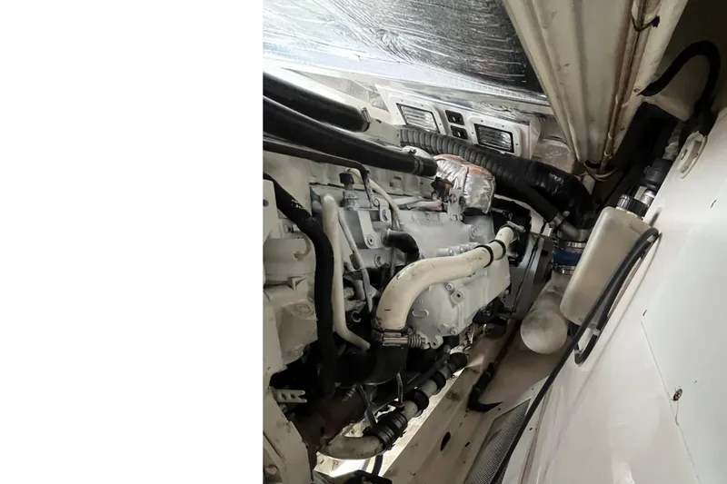  Yacht Photos Pics Engine compartment of a 2004 Cabo 35 Express boat, showcasing mechanical components.