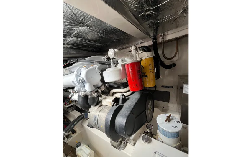  Yacht Photos Pics Engine compartment of a 2004 Cabo 35 Express boat, showcasing detailed components.