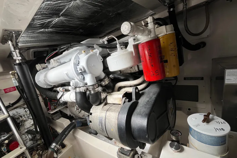  Yacht Photos Pics Engine compartment of a 2004 Cabo 35 Express boat, showcasing detailed mechanical components.