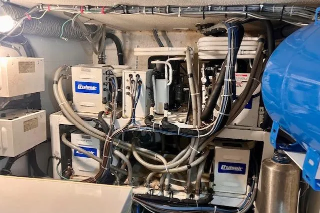 Abuelo Yacht Photos Pics Engine room of a 1989 HATTERES Convertible with complex wiring and machinery.