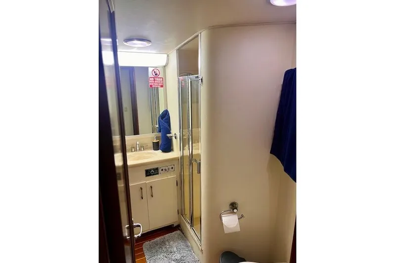 Abuelo Yacht Photos Pics Bathroom interior of 1989 HATTERES Convertible yacht, featuring shower and sink area.