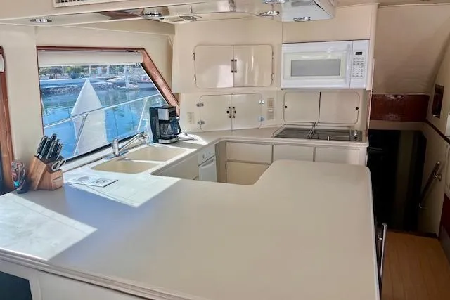 Abuelo Yacht Photos Pics 1989 HATTERES Convertible yacht kitchen with modern appliances and waterfront view.