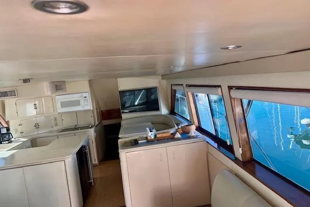 Abuelo Yacht Photos Pics Interior of 1989 HATTERES Convertible yacht with kitchen and seating area.