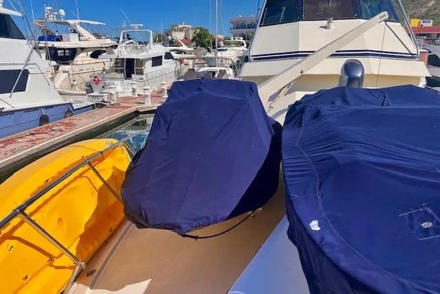 Abuelo Yacht Photos Pics 1989 HATTERES Convertible yacht docked with covered equipment on deck.