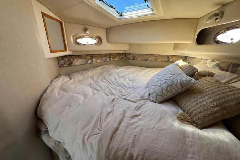 Pearl Yacht Photos Pics Cozy cabin interior of 1994 Sea Ray 440 Express Bridge with pillows and bedding.