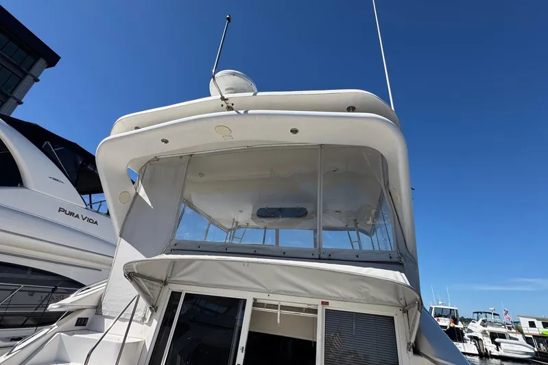 Pearl Yacht Photos Pics 1994 Sea Ray 440 Express Bridge yacht docked under clear blue sky.