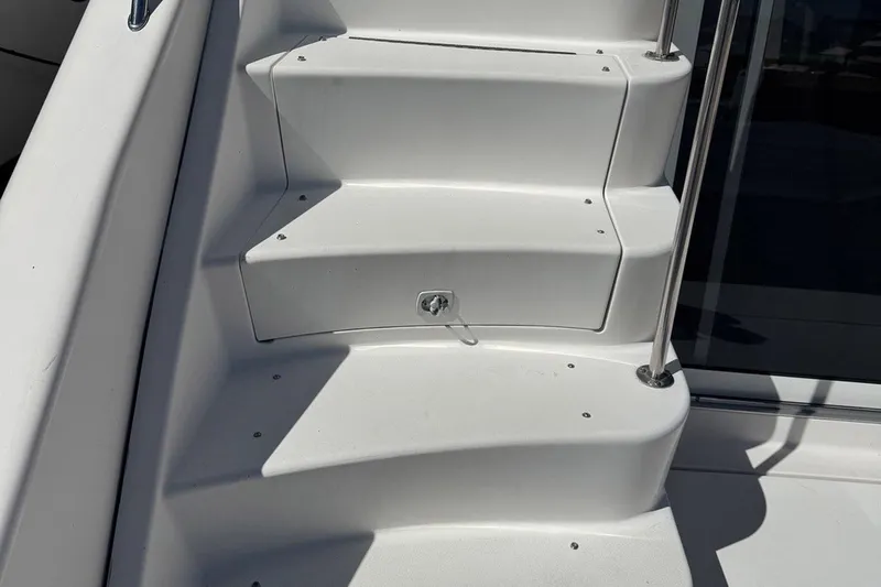 Pearl Yacht Photos Pics Steps on a 1994 Sea Ray 440 Express Bridge yacht, featuring sleek white design.