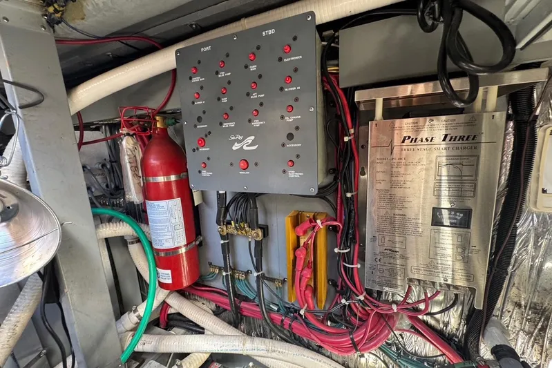 Pearl Yacht Photos Pics Engine room of 1994 Sea Ray 440 Express Bridge with control panel and fire extinguisher.