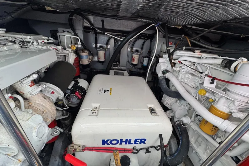 Pearl Yacht Photos Pics Engine room of 1994 Sea Ray 440 Express Bridge with Kohler generator and mechanical components.
