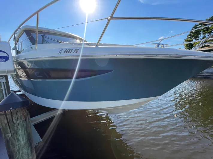 Funkytown 2 Yacht Photos Pics 2014 Jeanneau NC 11 boat docked, sunlit, with blue hull and sleek design.
