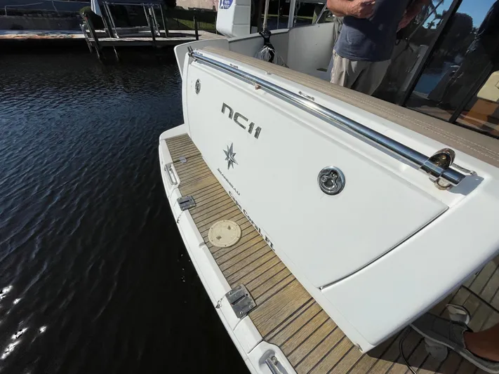 Funkytown 2 Yacht Photos Pics 2014 Jeanneau NC 11 boat stern with teak deck and chrome details.