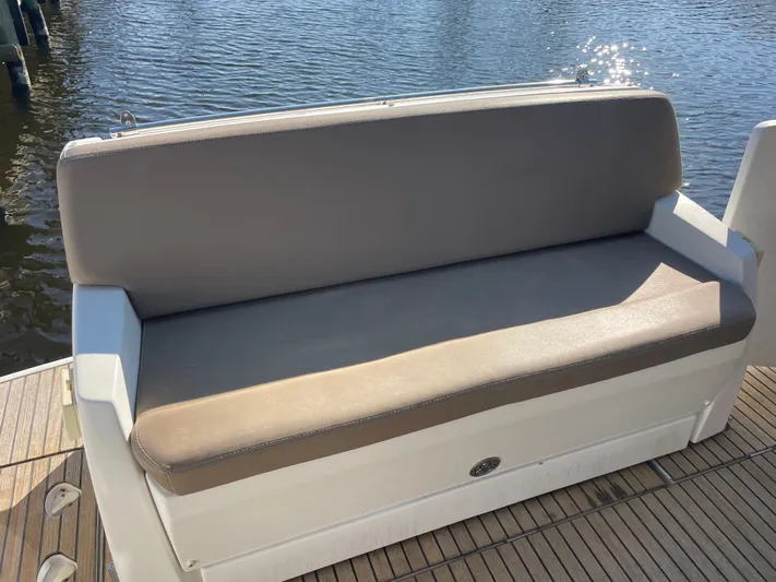 Funkytown 2 Yacht Photos Pics Comfortable seating on 2014 Jeanneau NC 11 boat, overlooking calm water.
