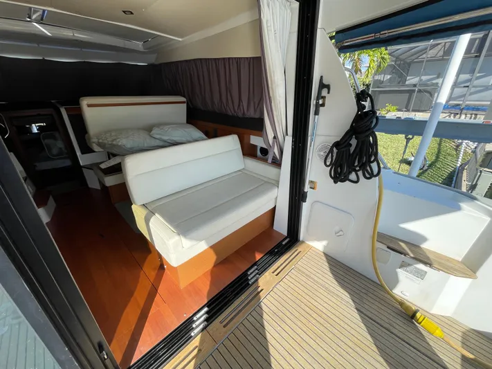 Funkytown 2 Yacht Photos Pics Interior of 2014 Jeanneau NC 11 boat with seating and wooden flooring.