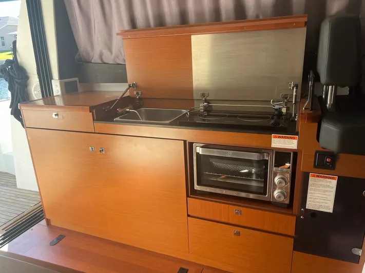 Funkytown 2 Yacht Photos Pics 2014 Jeanneau NC 11 boat kitchen with stove, sink, and oven.