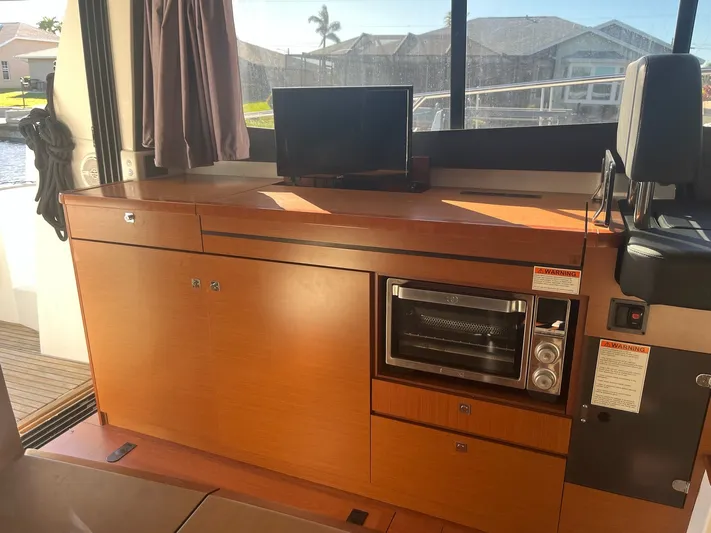 Funkytown 2 Yacht Photos Pics Interior of 2014 Jeanneau NC 11 yacht with wooden cabinetry and built-in oven.