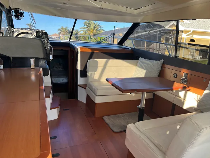 Funkytown 2 Yacht Photos Pics Interior of 2014 Jeanneau NC 11 boat with seating and table, featuring modern design.