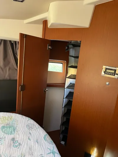 Funkytown 2 Yacht Photos Pics Interior of 2014 Jeanneau NC 11 boat cabin with wooden door and window.