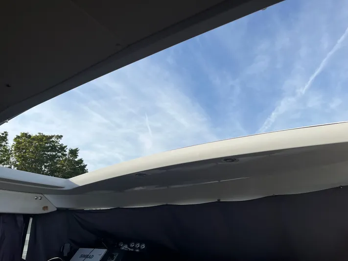 Funkytown 2 Yacht Photos Pics 2014 Jeanneau NC 11 boat interior with open roof and clear sky view.