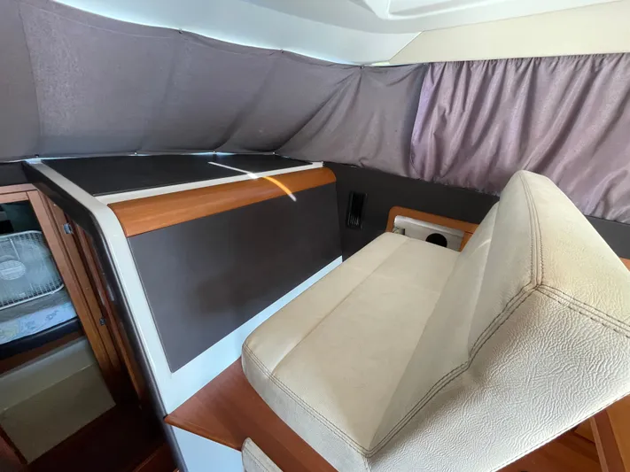 Funkytown 2 Yacht Photos Pics Interior of 2014 Jeanneau NC 11 boat with beige seating and wooden accents.
