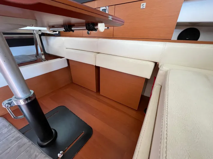 Funkytown 2 Yacht Photos Pics Interior of 2014 Jeanneau NC 11 boat with wooden flooring and white seating.