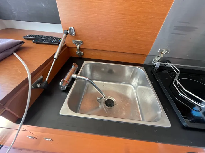 Funkytown 2 Yacht Photos Pics Stainless steel sink in 2014 Jeanneau NC 11 boat kitchen with wooden cabinetry.