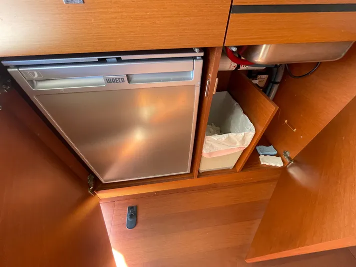 Funkytown 2 Yacht Photos Pics Kitchen area of 2014 Jeanneau NC 11 with fridge, sink, and storage.