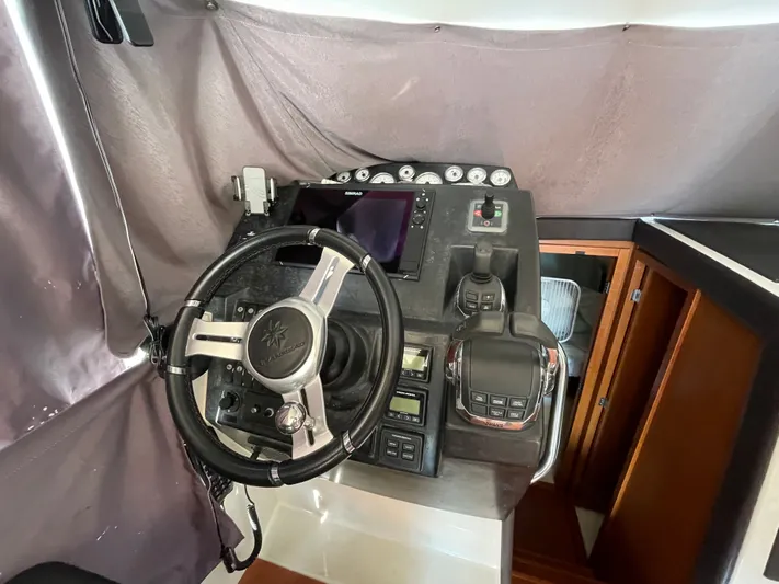 Funkytown 2 Yacht Photos Pics Steering console of a 2014 Jeanneau NC 11 boat with modern controls and navigation equipment.