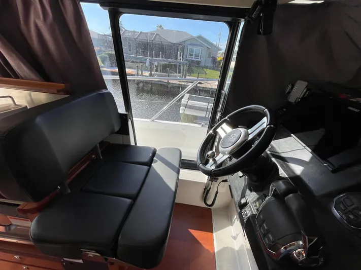 Funkytown 2 Yacht Photos Pics Interior of 2014 Jeanneau NC 11 boat, featuring steering wheel and seating.