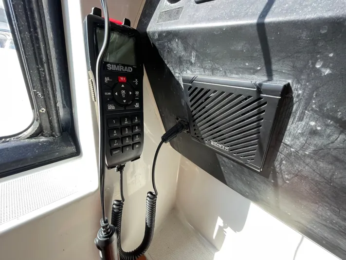 Funkytown 2 Yacht Photos Pics Simrad marine radio and speaker on 2014 Jeanneau NC 11 boat dashboard.