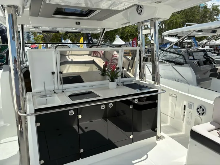 Jeanneau Yacht Photos Pics 2024 Jeanneau 12.5 Walk interior with sleek kitchen and seating area.