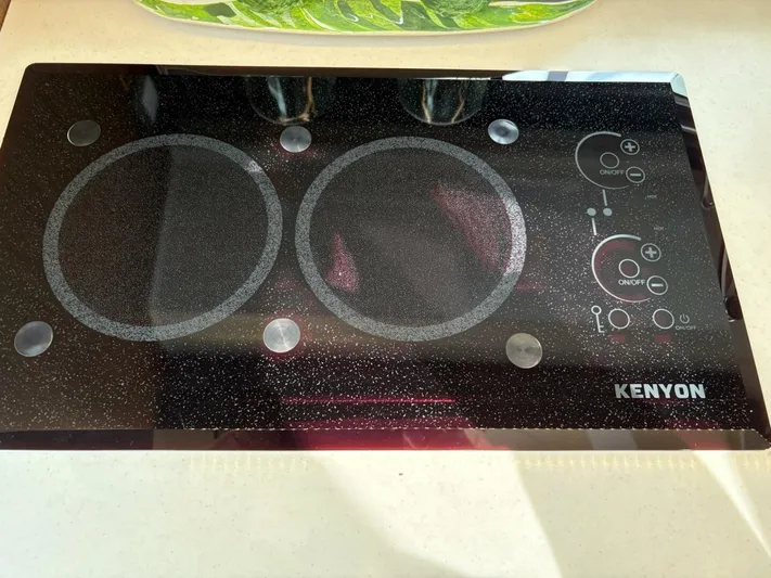 Jeanneau Yacht Photos Pics Kenyon electric cooktop on Jeanneau 12.5 Walk 2024 model yacht kitchen.