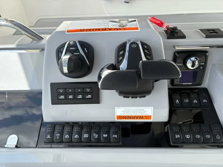 Jeanneau Yacht Photos Pics Control panel of 2024 Jeanneau 12.5 Walk boat with various switches and controls.