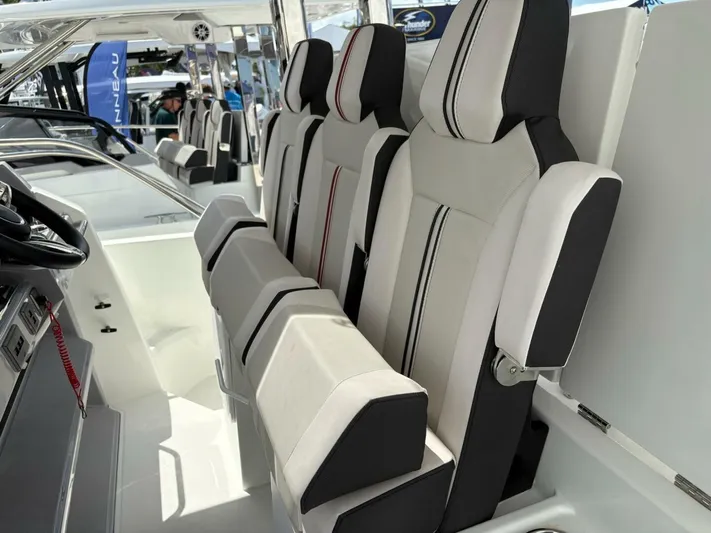 Jeanneau Yacht Photos Pics 2024 Jeanneau 12.5 Walk interior with modern seating and steering wheel.