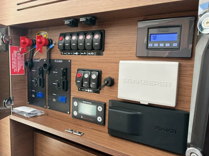 Jeanneau Yacht Photos Pics Control panel of 2024 Jeanneau 12.5 Walk boat with various switches and displays.