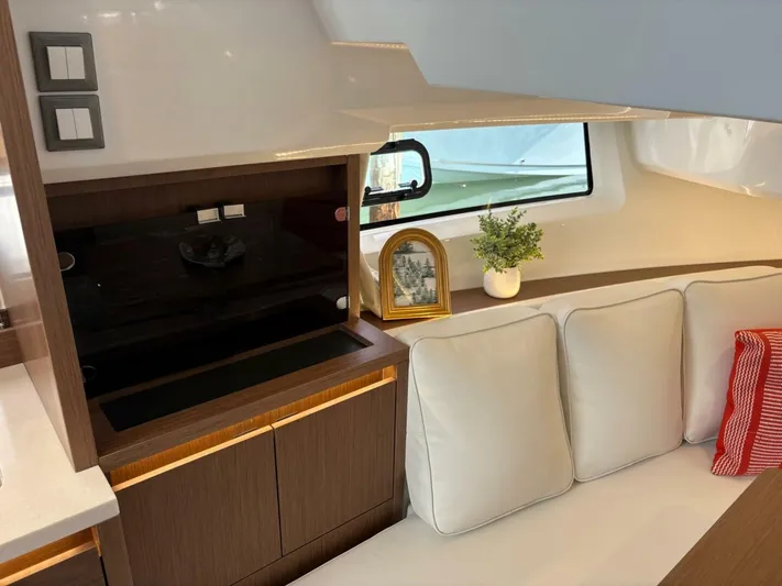 Jeanneau Yacht Photos Pics 2024 Jeanneau 12.5 Walk interior with modern seating and elegant decor.
