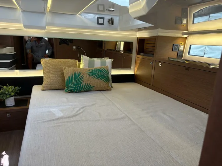 Jeanneau Yacht Photos Pics Luxurious interior of 2024 Jeanneau 12.5 Walk, featuring a cozy bed and elegant decor.