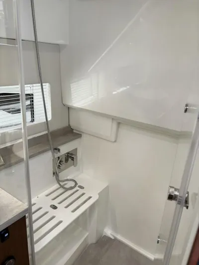 Jeanneau Yacht Photos Pics 2024 Jeanneau 12.5 Walk interior shower area with modern fixtures and sleek design.