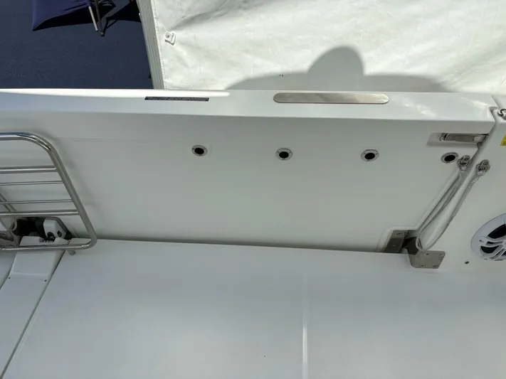 Jeanneau Yacht Photos Pics 2024 Jeanneau 12.5 Walk boat interior detail with stainless steel railing and speaker.